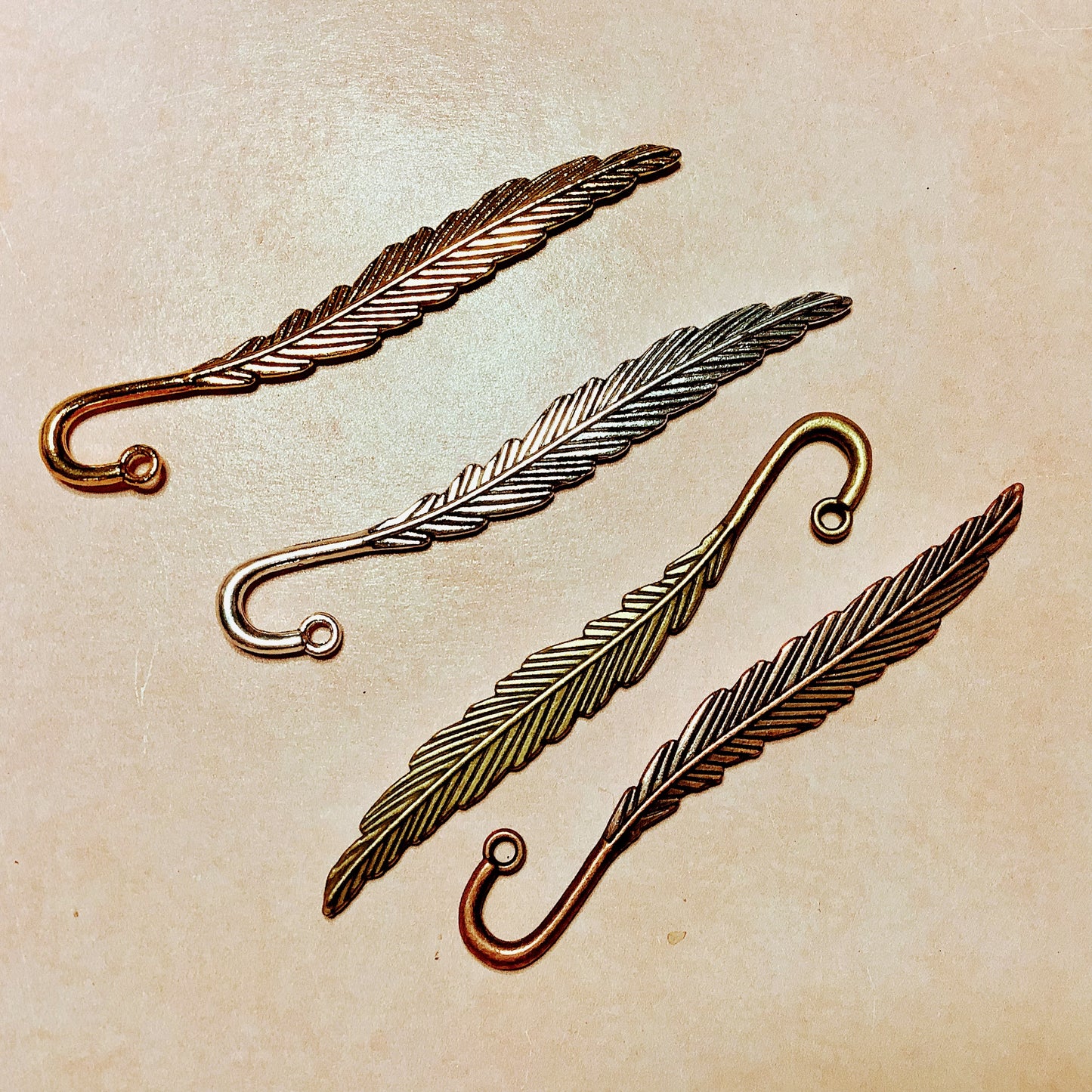 Feather hooked embossed metal bookmark