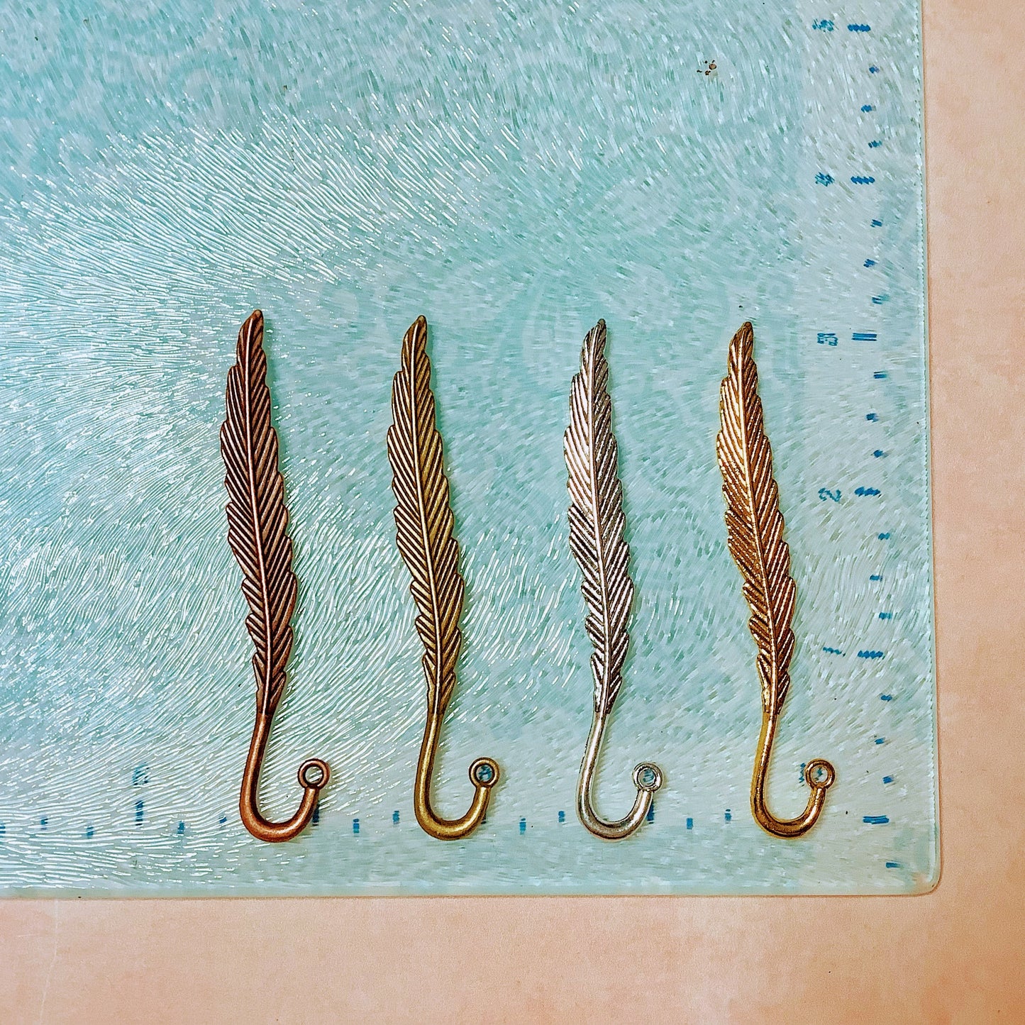 Feather hooked embossed metal bookmark