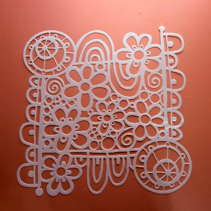 Wildflower Wheel Mylar stencil 6 inch showing daisy swirl and wheel motif design cut from durable mylar