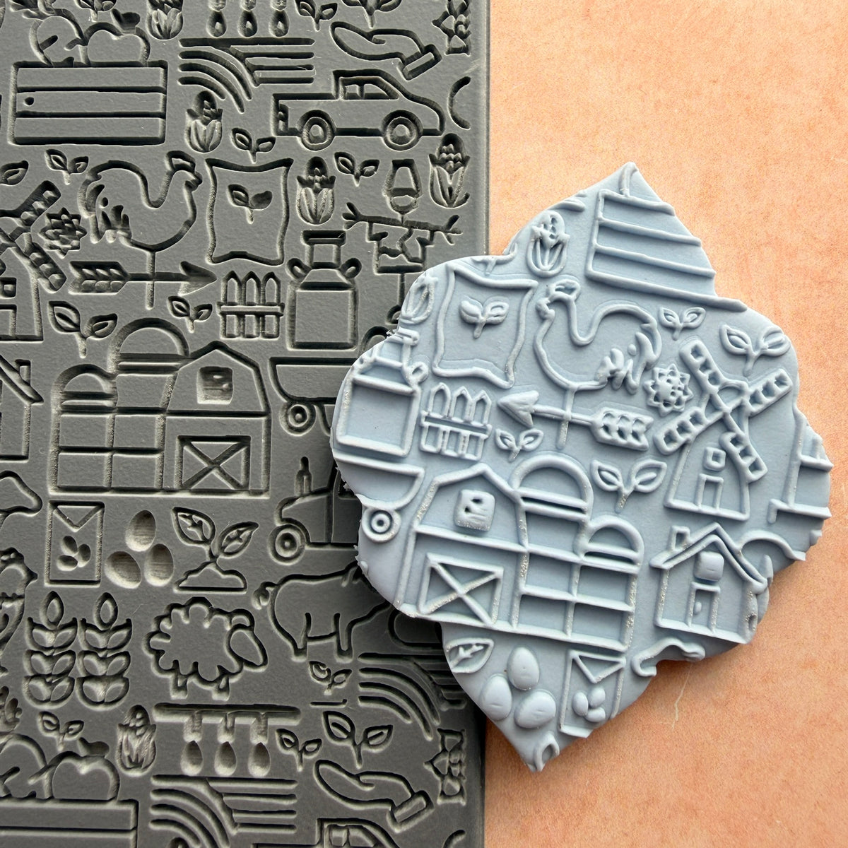 On the Farm rubber stamp beside impressed polymer clay piece showing barn windmill rooster and farm scene detail