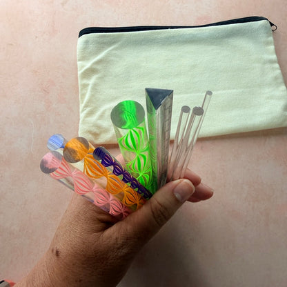 Dotting and Pressing Set for polymer clay showing all 9 acrylic rods including triangle ruler rod fanned across surface