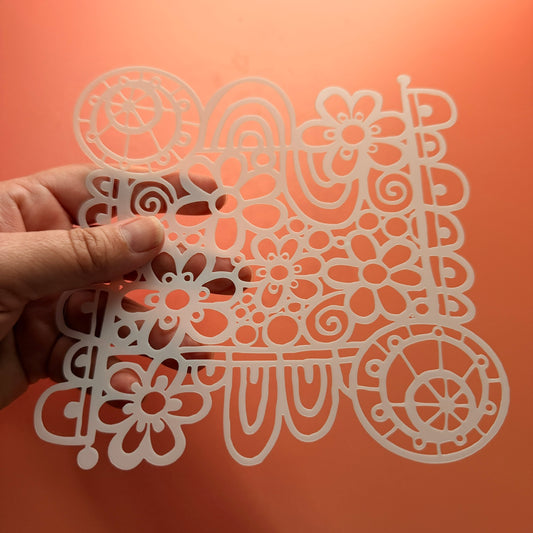 Wildflower Wheel Mylar stencil close up showing flower and rainbow swirl pattern detail