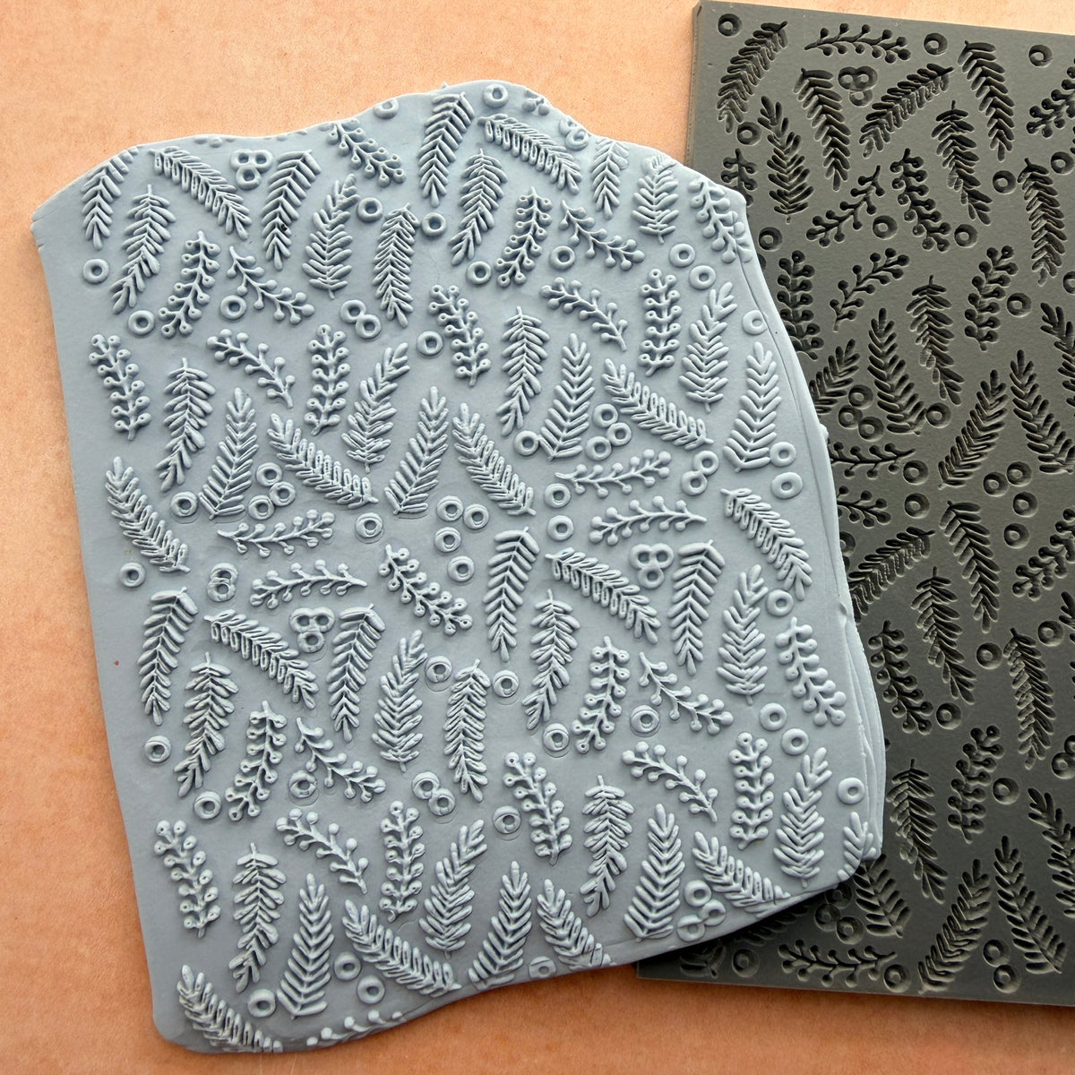 Brambleberries rubber stamp beside impressed polymer clay slab showing fern frond and berry pattern detail